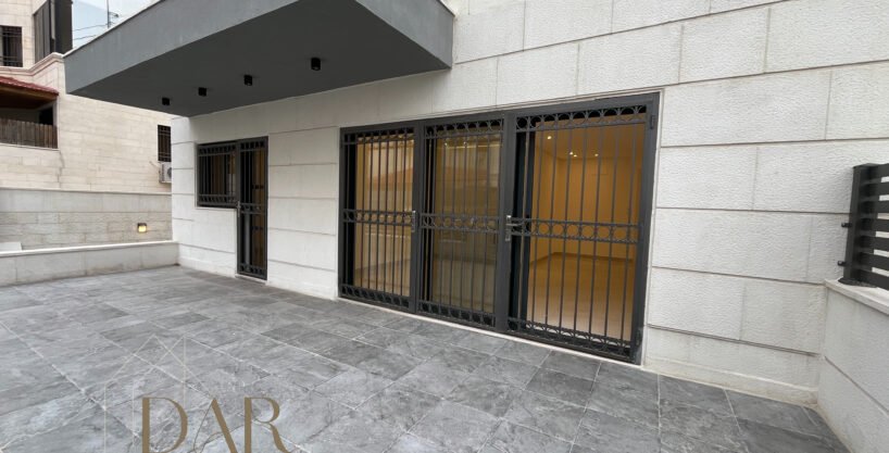 Ground-Floor Apartment with Terrace in Al Rabieh For Sale The unit features two separate entrances, adding convenience and flexibility for daily use. The apartment also includes two private parking garages, providing secure and direct access for residents. The outdoor terrace extends the living space outward and offers a pleasant setting for seating and leisure. This residence represents a solid offering within Jordan’s residential market for buyers seeking ground-floor living with functional outdoor areas and dedicated parking in a well-established neighborhood.