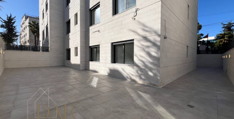 This semi-ground floor apartment offers 158 sqm of internal living space complemented by 190 sqm of private outdoor terrace areas. Located in Al Rawnak, Amman, the property benefits from a practical residential layout suitable for comfortable everyday living. The unit features two separate entrances, adding flexibility and convenience for family use and guest reception. The outdoor terrace significantly extends the living space and provides a pleasant setting for seating, leisure, and social gatherings. This residence represents an appealing apartment option within Jordan’s residential market for buyers seeking generous outdoor areas combined with functional indoor layouts in an established neighborhood setting.